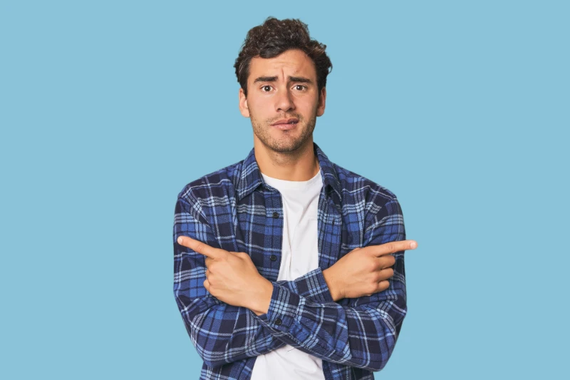 Man pointing to both side.